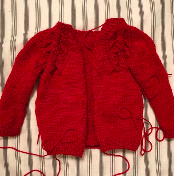 Work in Progress WIP liliana Sweater by Anne Dresow. Hand knit baby sweater, heirloom knits, red alpaca yarn.